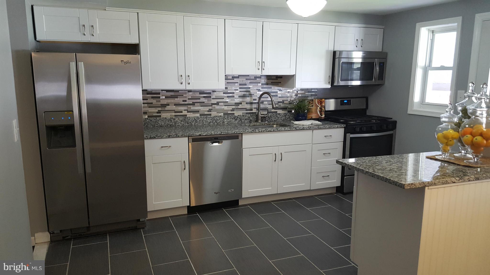 1034 Middleborough Road Baltimore, MD 21221 - Photo 8 of 29 a kitchen with stainless steel appliances granite countertop a sink stove and refrigerator