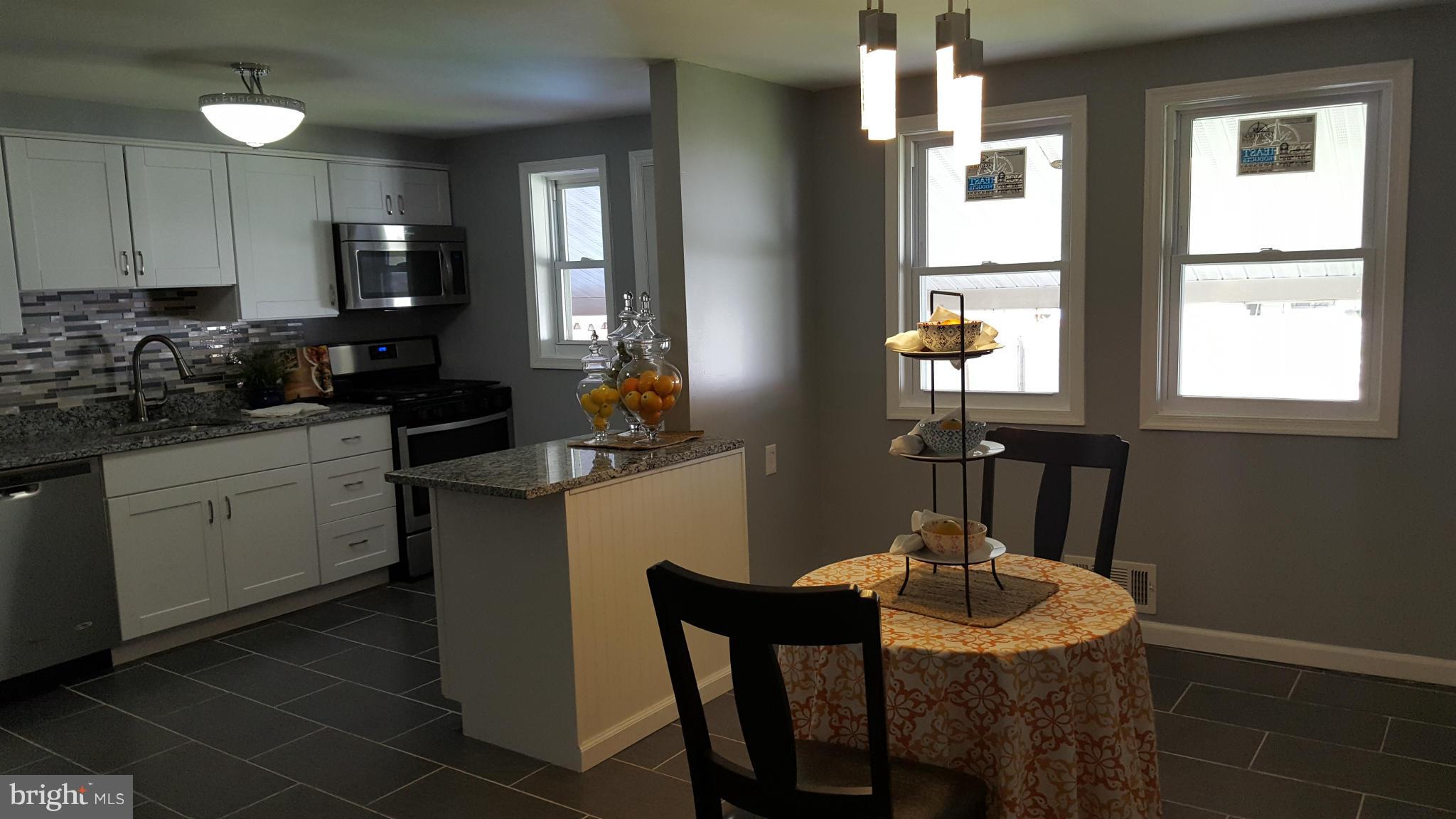 1034 Middleborough Road Baltimore, MD 21221 - Photo 9 of 29 a kitchen with a table chairs sink and cabinets