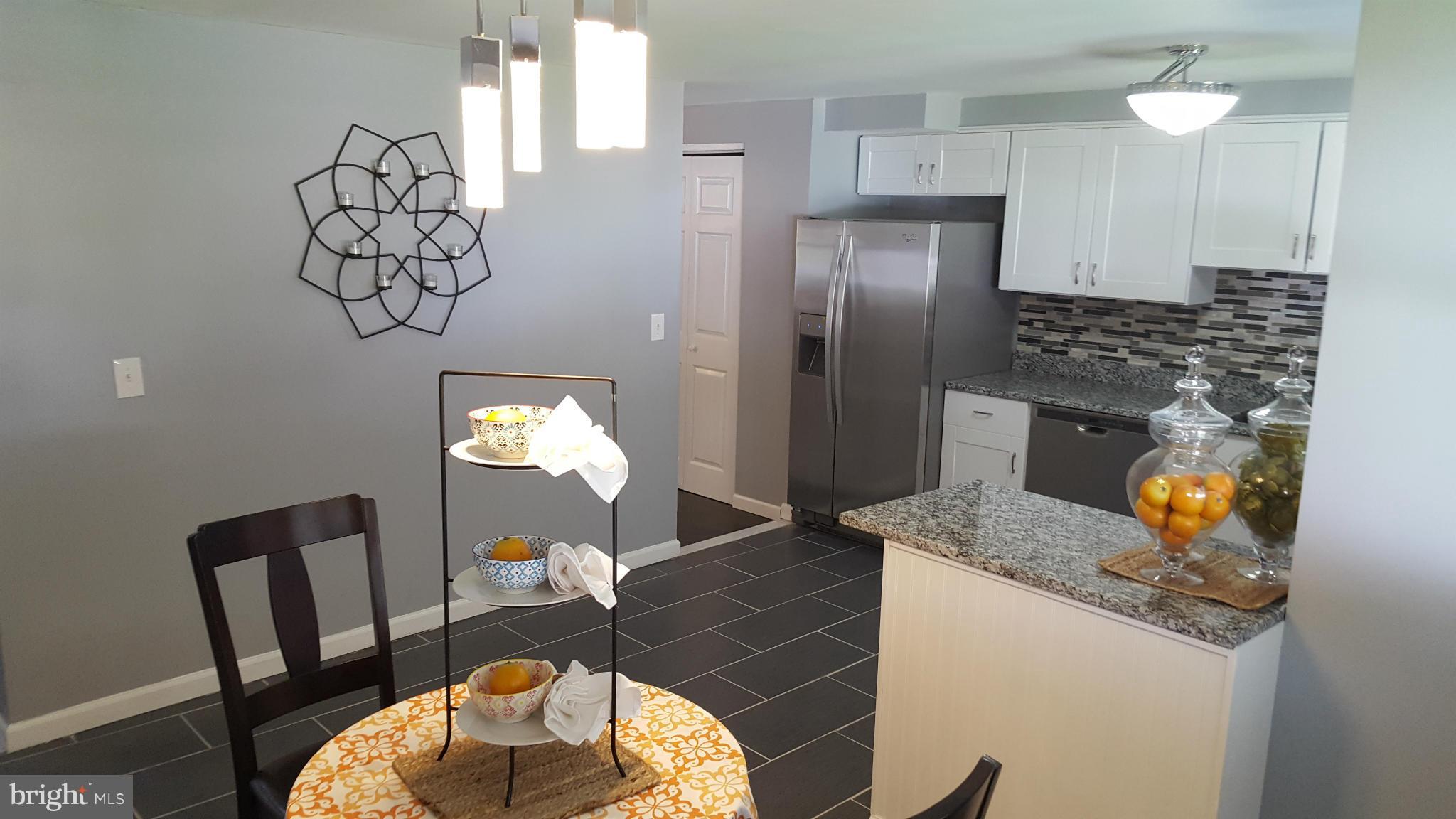 1034 Middleborough Road Baltimore, MD 21221 - Photo 10 of 29 a kitchen with granite countertop a table and chairs in it