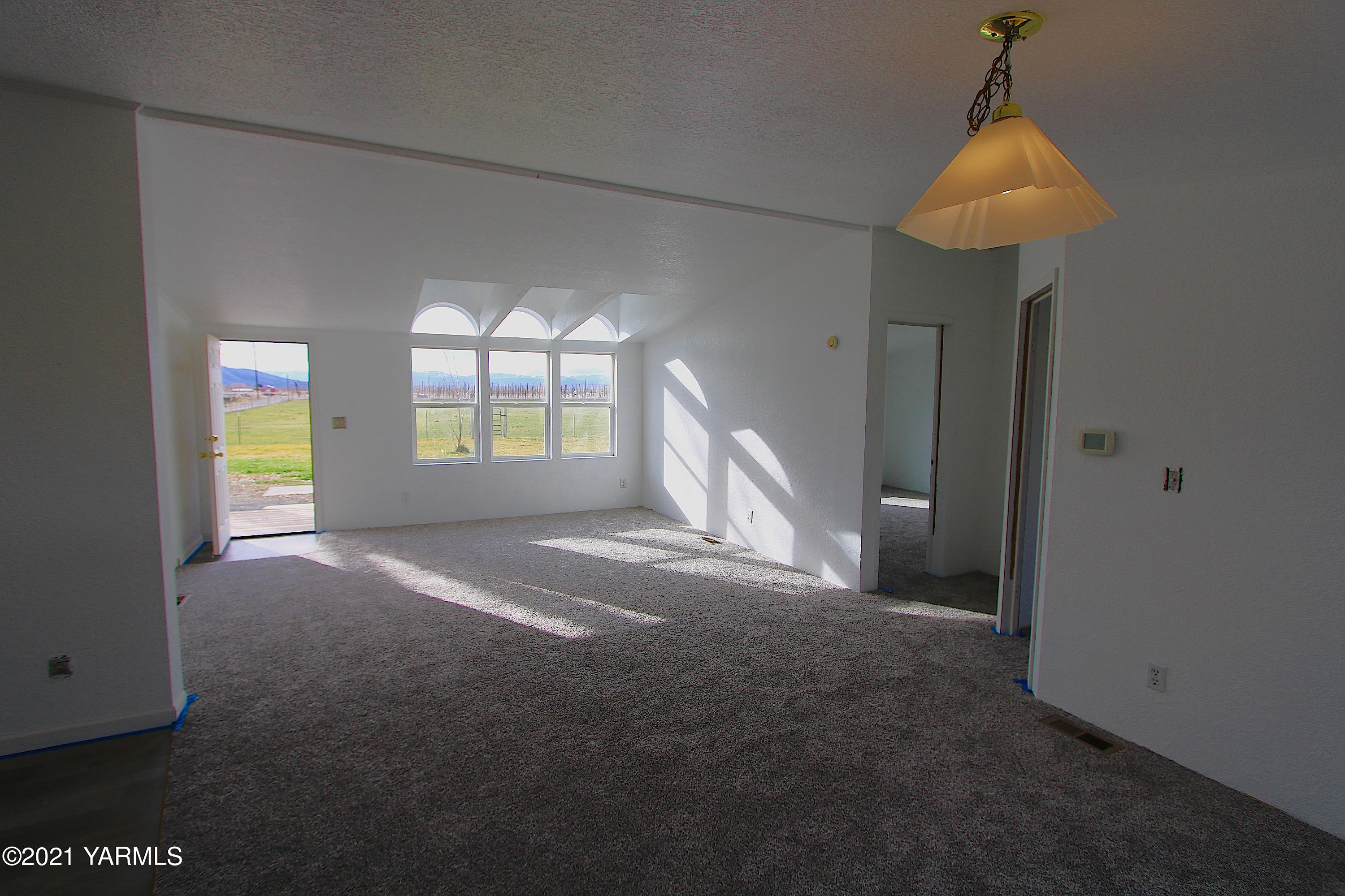 731 South Rivard Road Moxee, WA 98936 - Photo 8 of 26 a view of a room with window and chandelier fan
