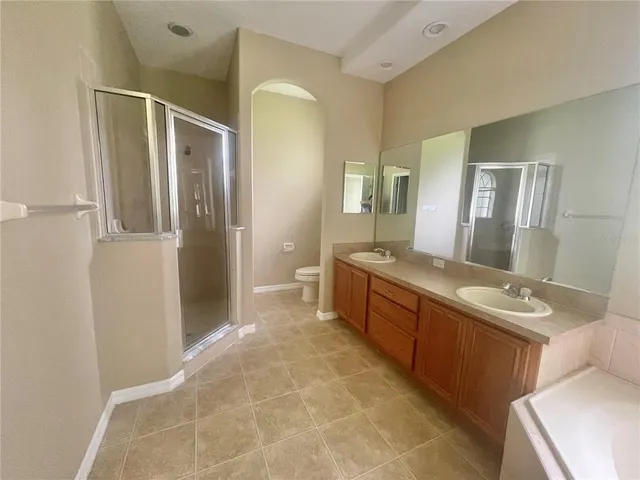 a spacious bathroom with a granite countertop sink mirror and a