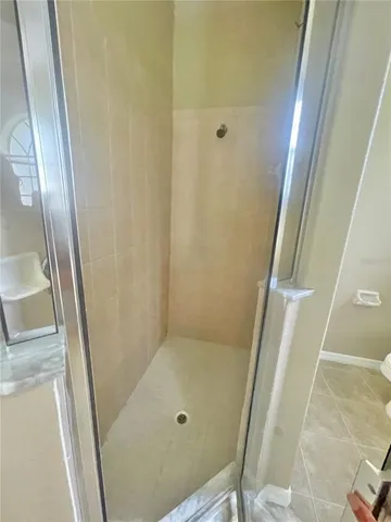 a bathroom with a sink and a glass door shower