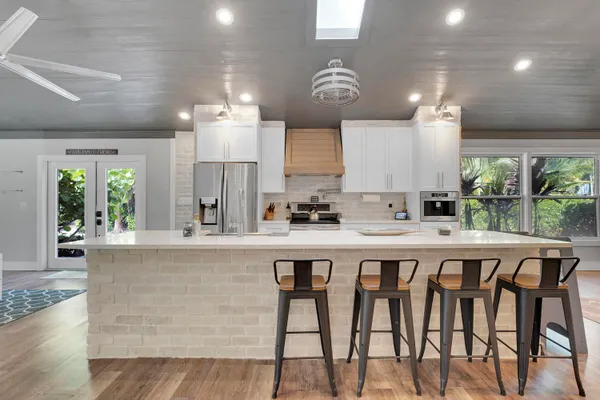 a large kitchen with a table and chairs