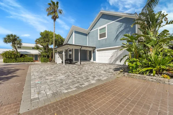 a front view of a house with a yard and a garage
