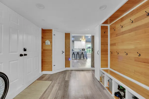 a view of a hallway with wooden floor and staircase