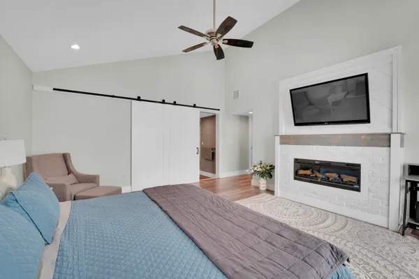 a bedroom with a bed and a fireplace