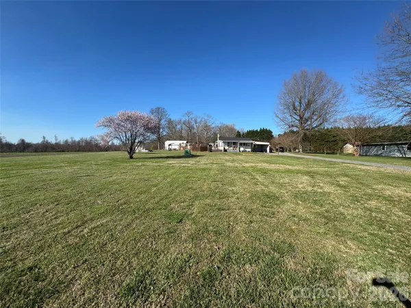 a view of a field with an trees