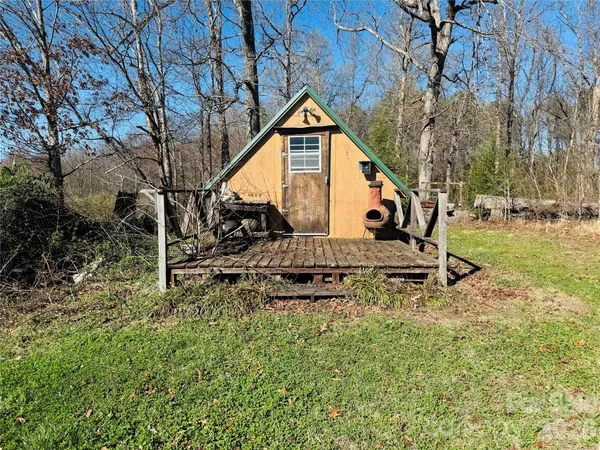 a view of a house with a yard and sitting area