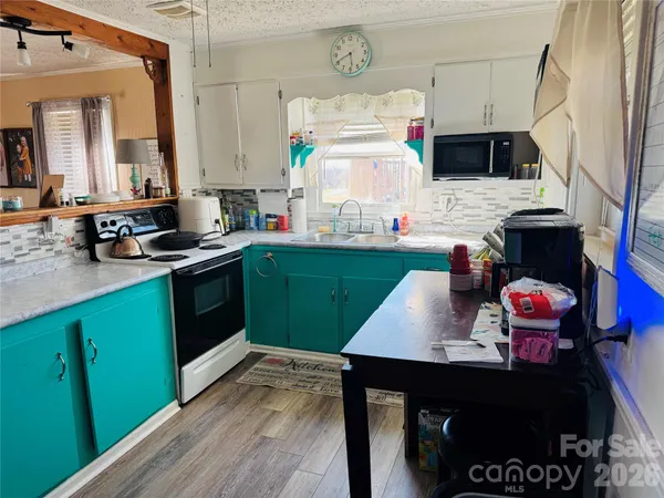 a kitchen with a sink appliances and cabinets