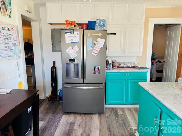 a kitchen with refrigerator and cabinets