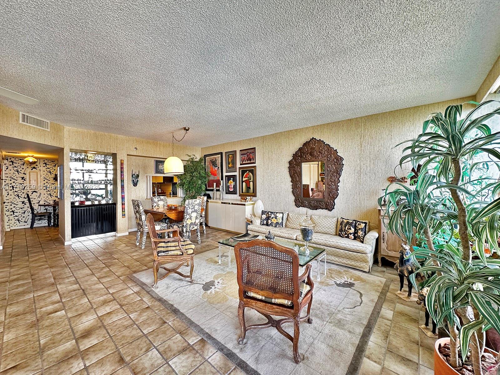 520 Brickell Key Drive, Unit A1802 Miami, FL 33131 - Photo 11 of 35 a living room with furniture a table and a potted plant