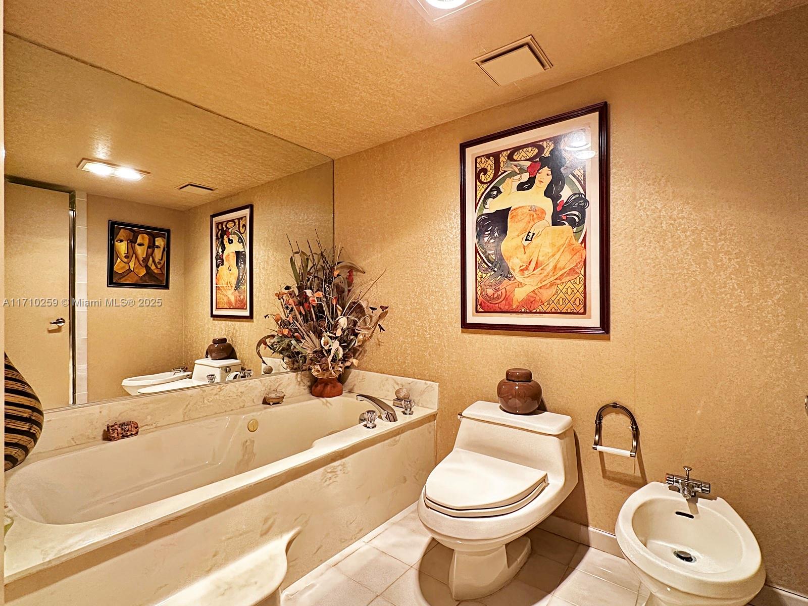 520 Brickell Key Drive, Unit A1802 Miami, FL 33131 - Photo 19 of 35 a bathroom with a toilet sink and mirror