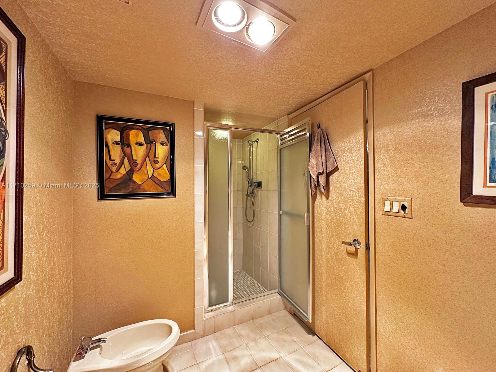 520 Brickell Key Drive, Unit A1802 Miami, FL 33131 - Photo 20 of 35 a bathroom with a shower toilet and sink
