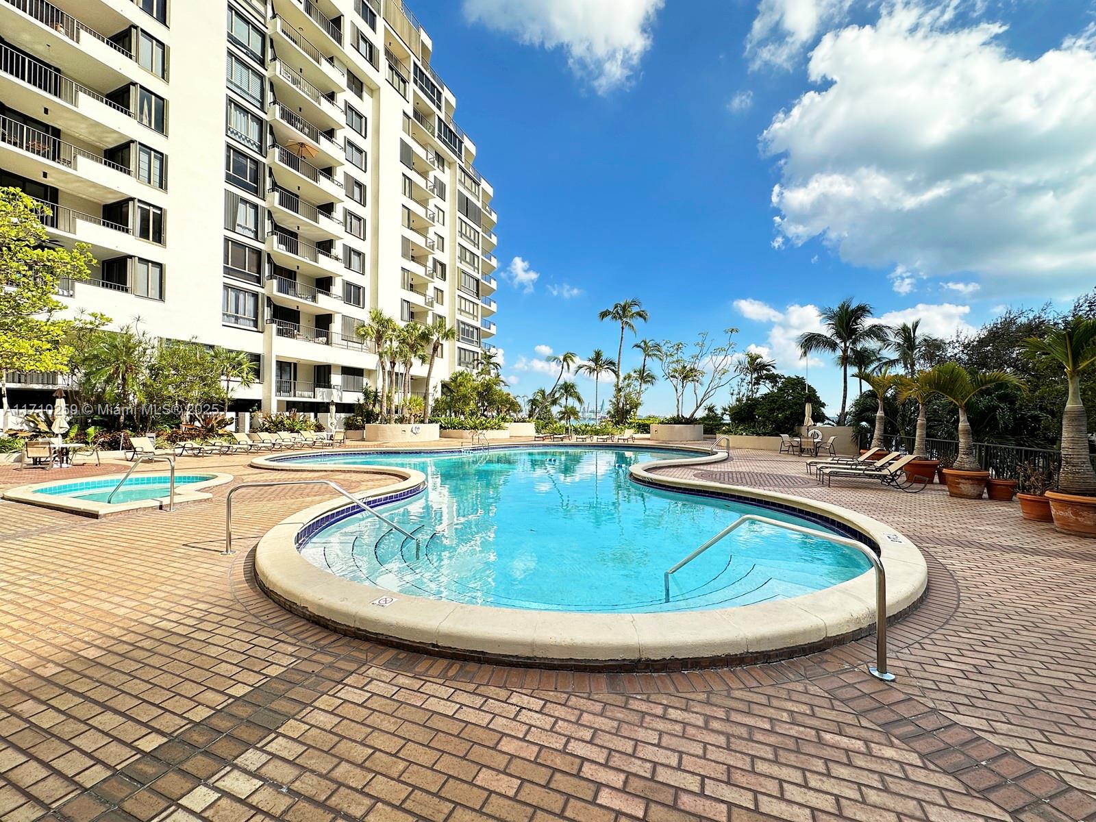 520 Brickell Key Drive, Unit A1802 Miami, FL 33131 - Photo 26 of 35 a view of a swimming pool with outdoor seating