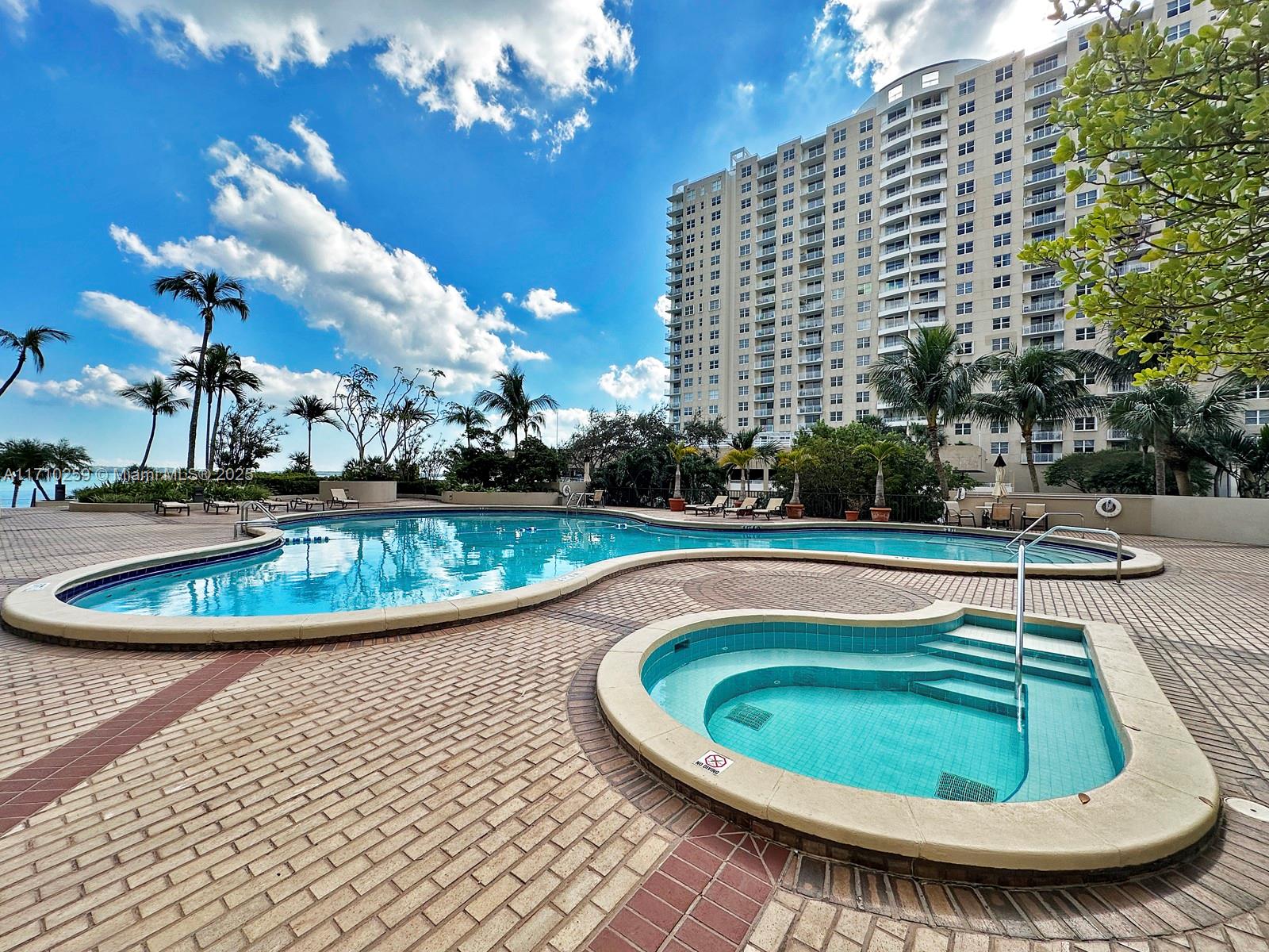 520 Brickell Key Drive, Unit A1802 Miami, FL 33131 - Photo 27 of 35 a view of a swimming pool with a yard