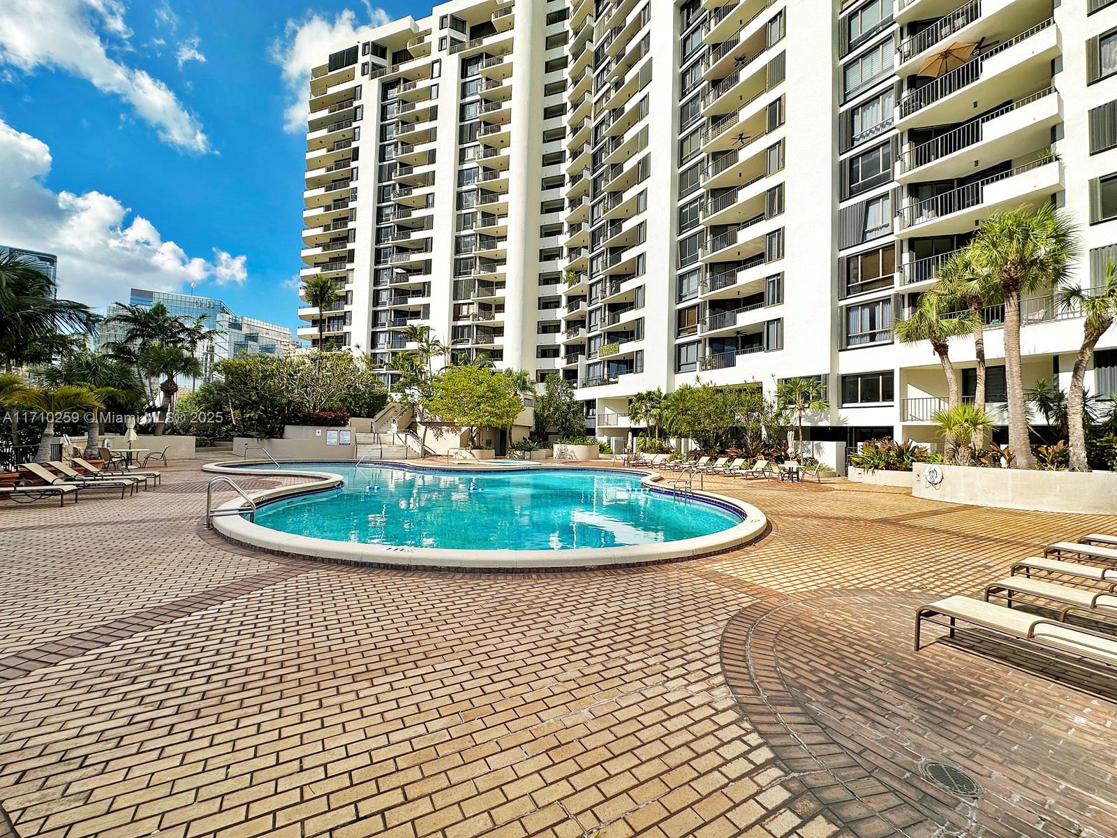 520 Brickell Key Drive, Unit A1802 Miami, FL 33131 - Photo 28 of 35 a view of a swimming pool with a lounge chairs