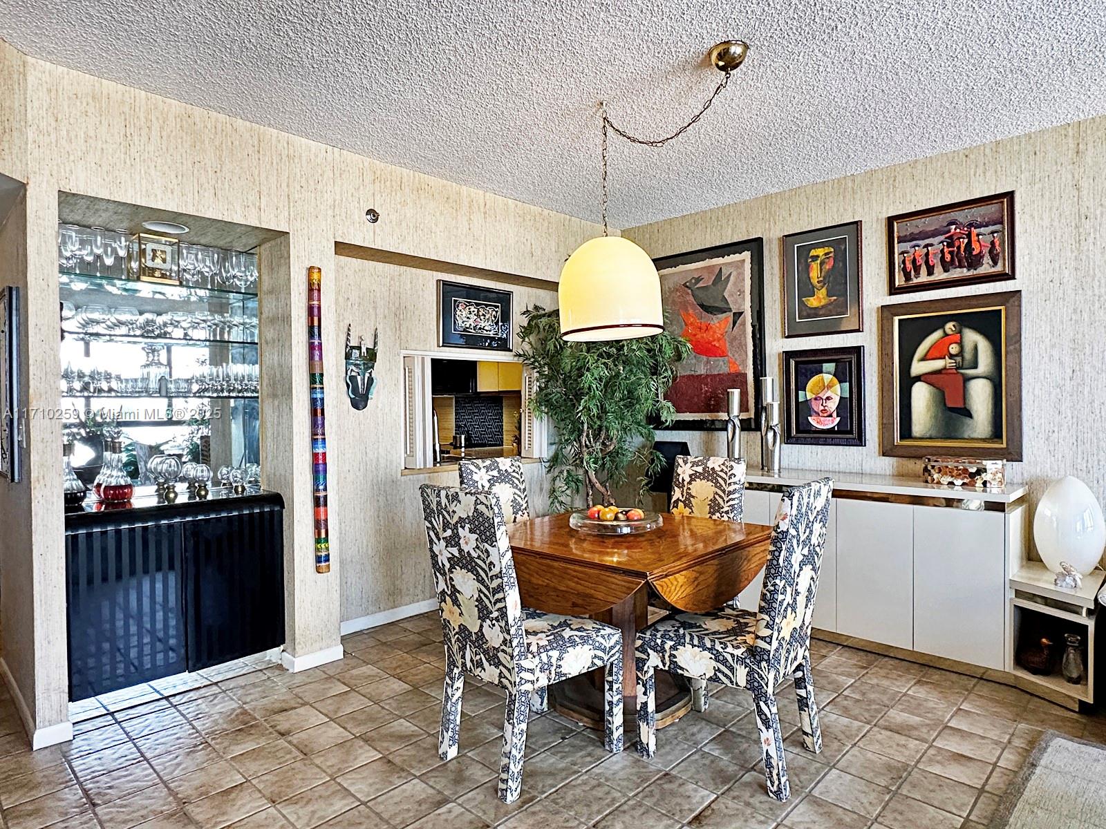 520 Brickell Key Drive, Unit A1802 Miami, FL 33131 - Photo 8 of 35 a view of a dining room with furniture window and wooden floor