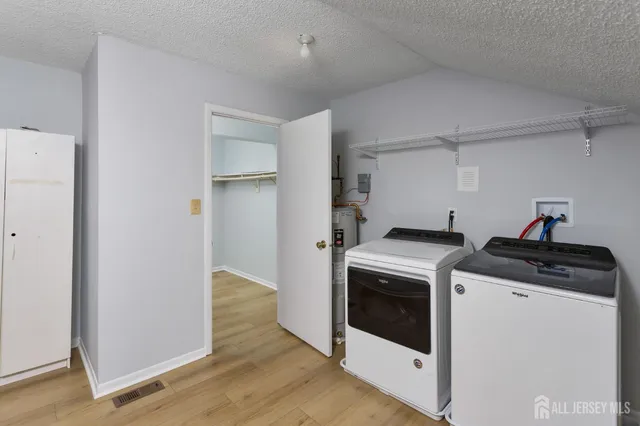 a view of storage and utility room with washer and dryer