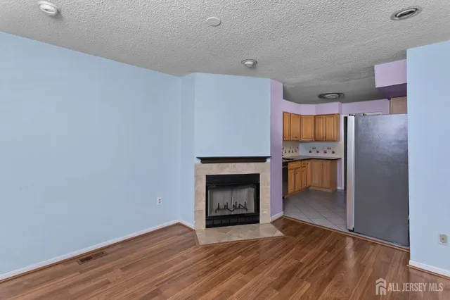 a room with a fireplace and a wooden floor