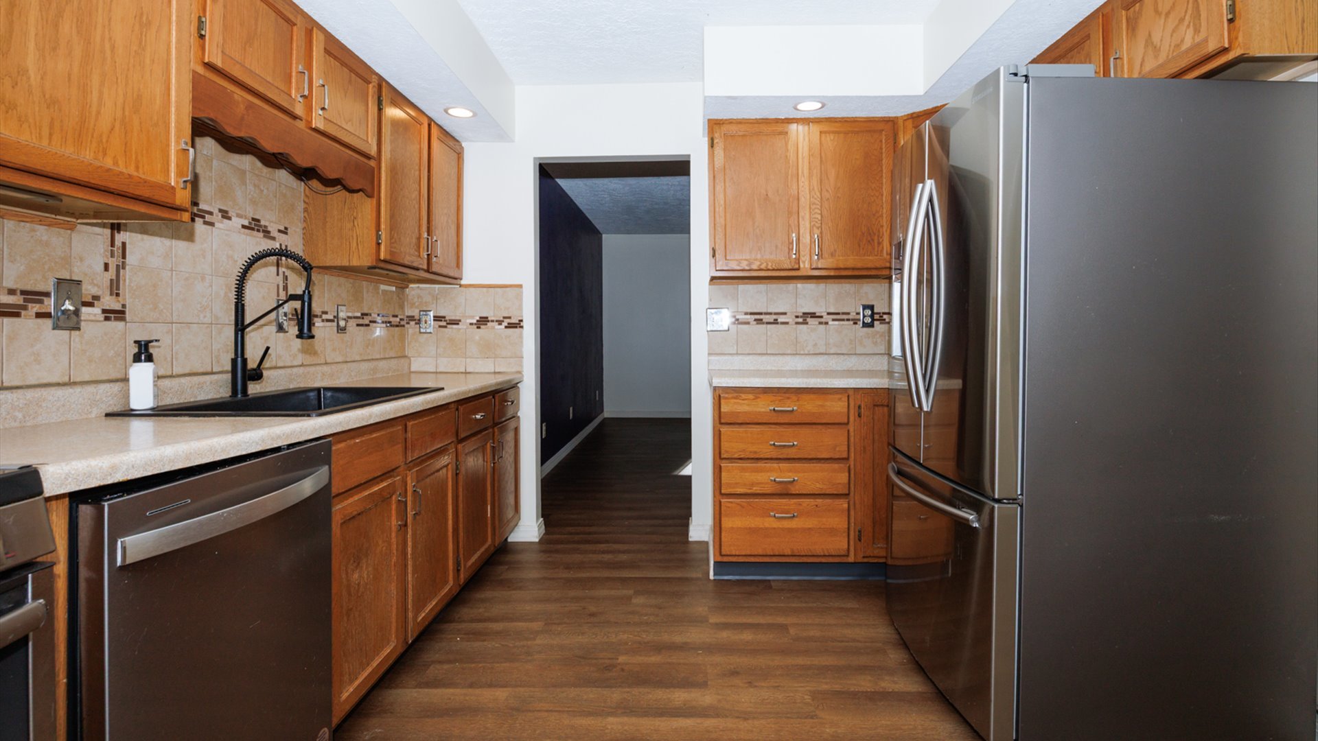800 West Hamilton Street Atlanta, IL 61723 - Photo 16 of 44 a kitchen with stainless steel appliances granite countertop a refrigerator and a sink