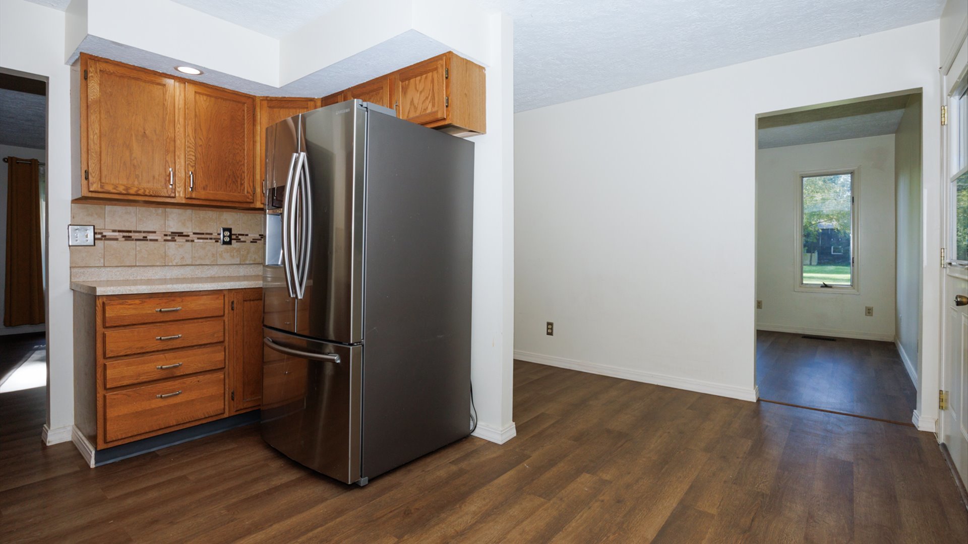800 West Hamilton Street Atlanta, IL 61723 - Photo 17 of 44 a kitchen with a refrigerator and cabinets