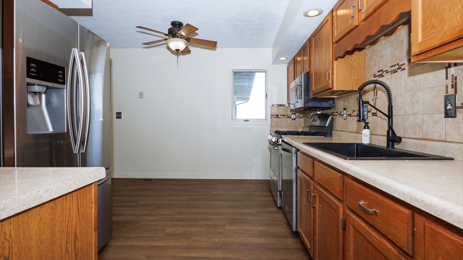 800 West Hamilton Street Atlanta, IL 61723 - Photo 18 of 44 a kitchen with stainless steel appliances granite countertop a sink and a refrigerator