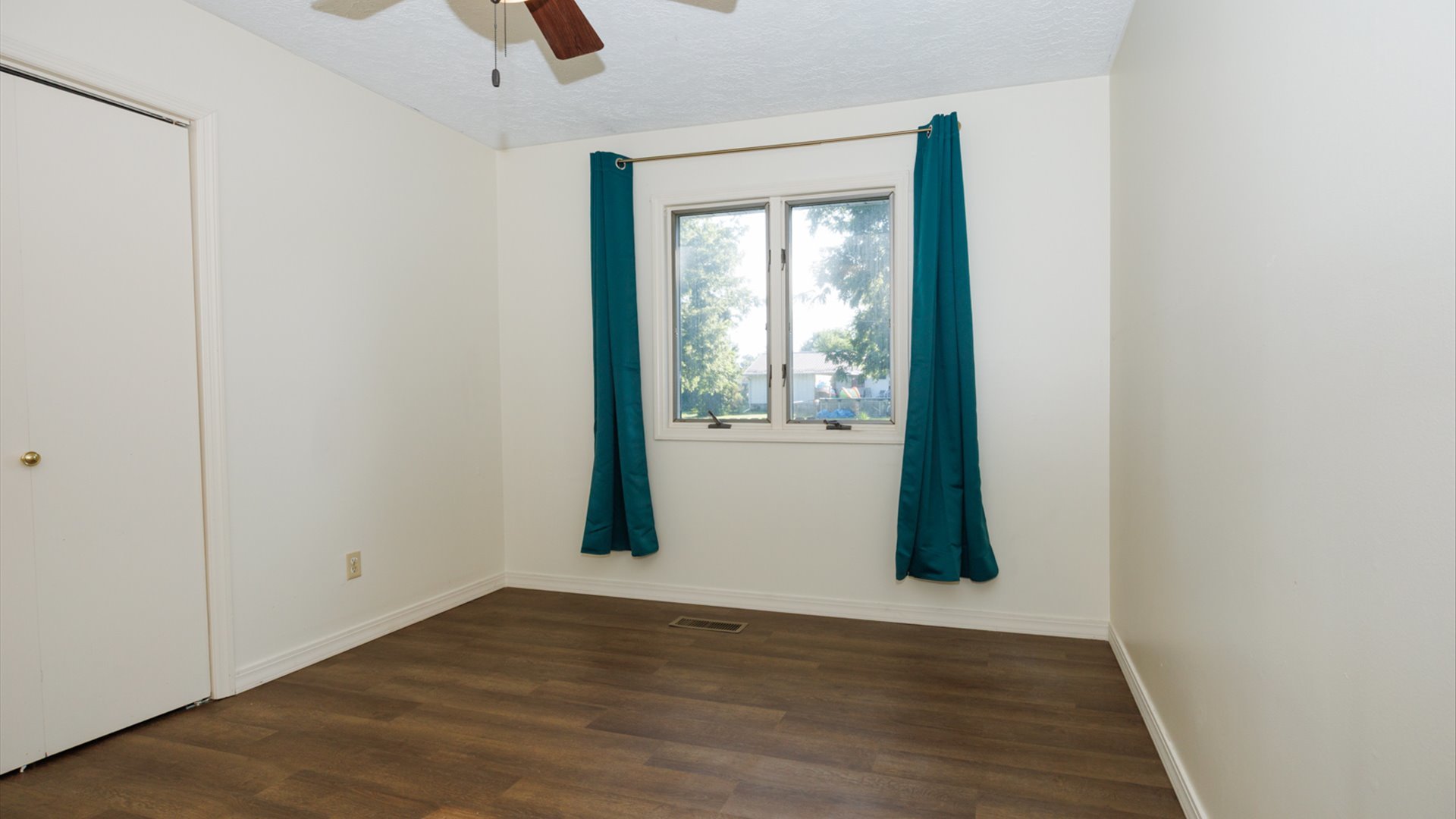 800 West Hamilton Street Atlanta, IL 61723 - Photo 23 of 44 an empty room with wooden floor and windows