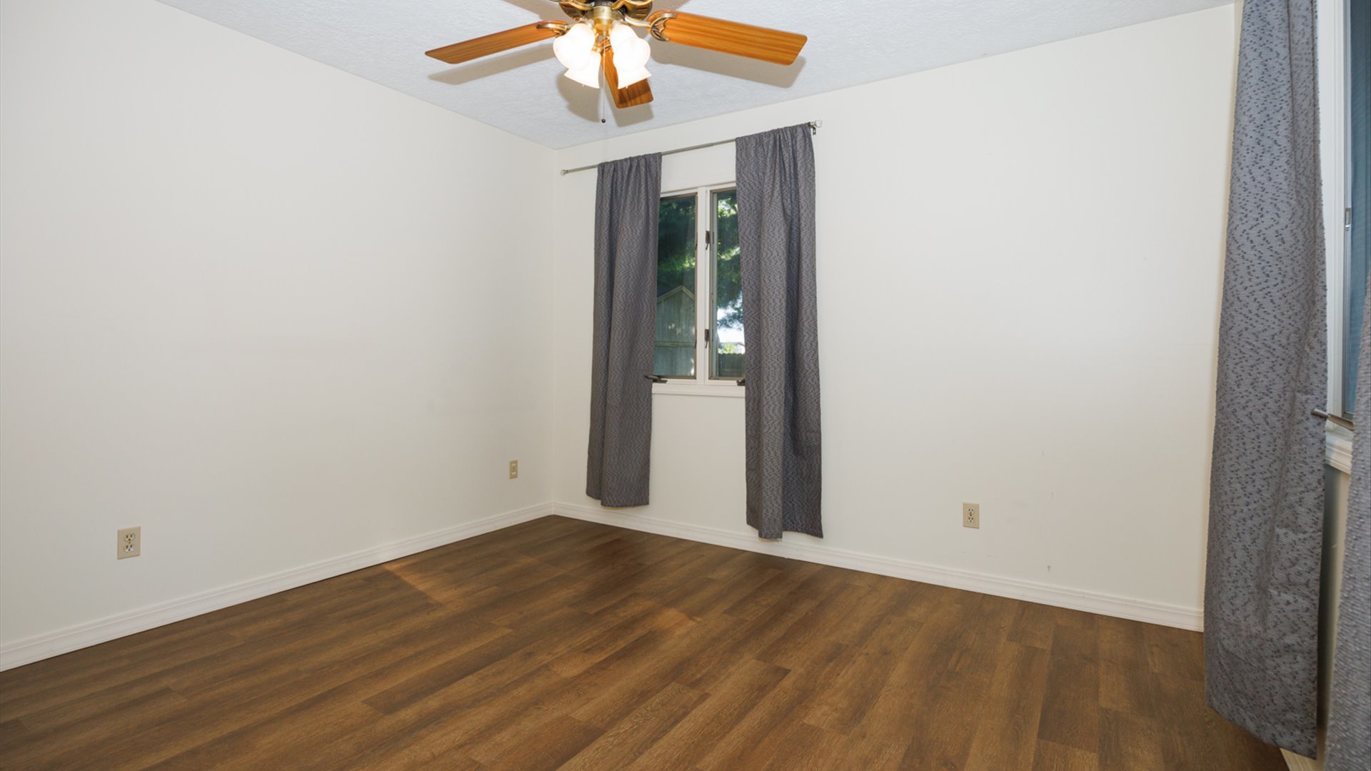 800 West Hamilton Street Atlanta, IL 61723 - Photo 26 of 44 an empty room with wooden floor chandelier fan and closet area
