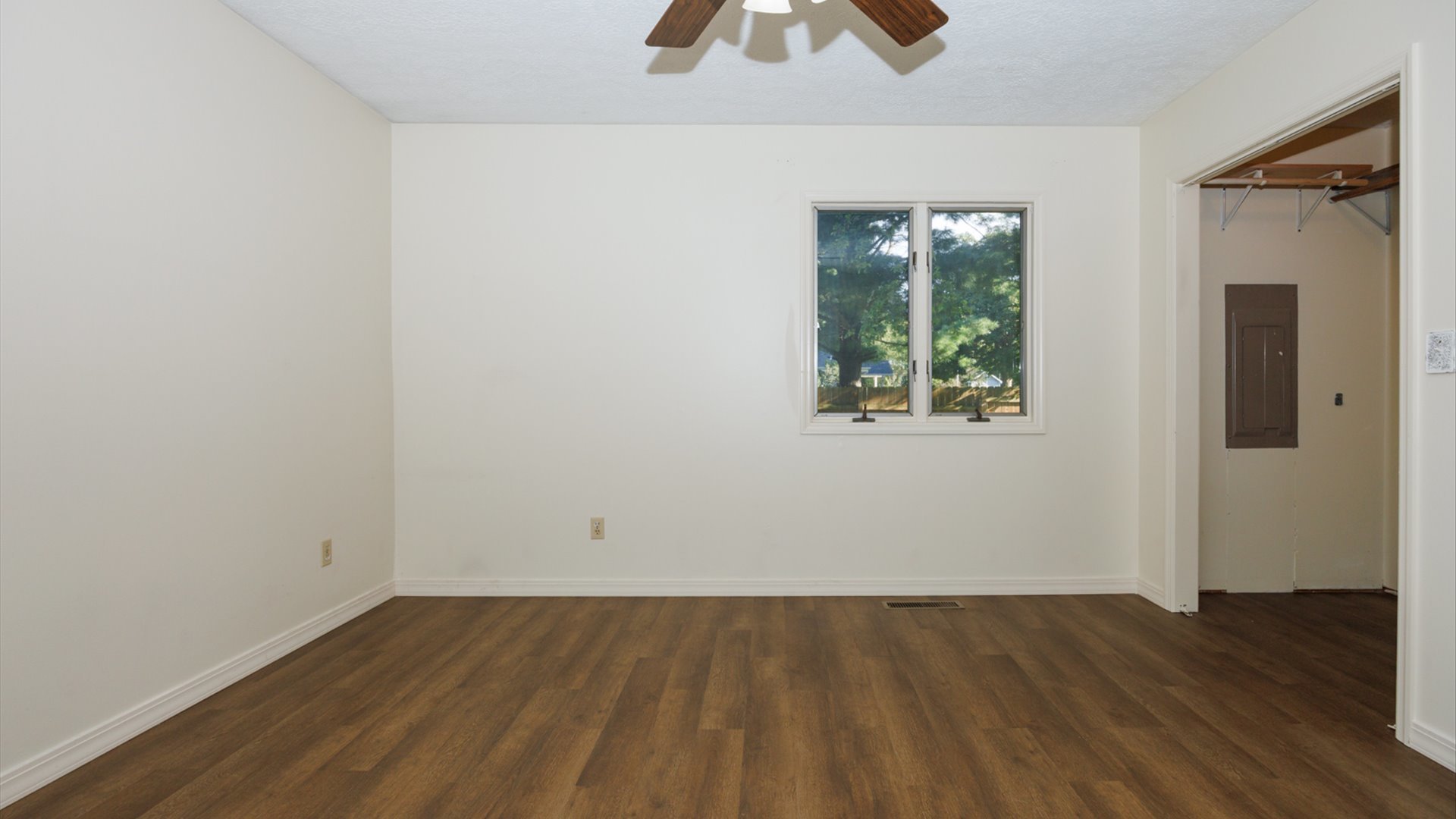 800 West Hamilton Street Atlanta, IL 61723 - Photo 30 of 44 an empty room with wooden floor and windows