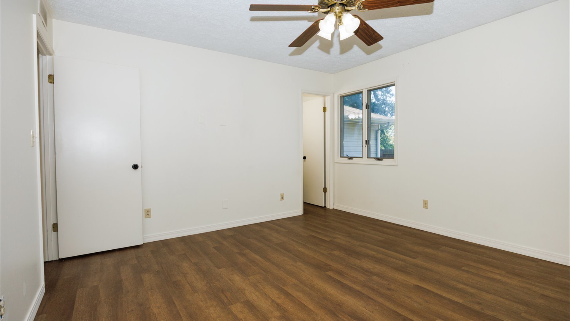 800 West Hamilton Street Atlanta, IL 61723 - Photo 34 of 44 a view of an empty room with wooden floor and a ceiling fan