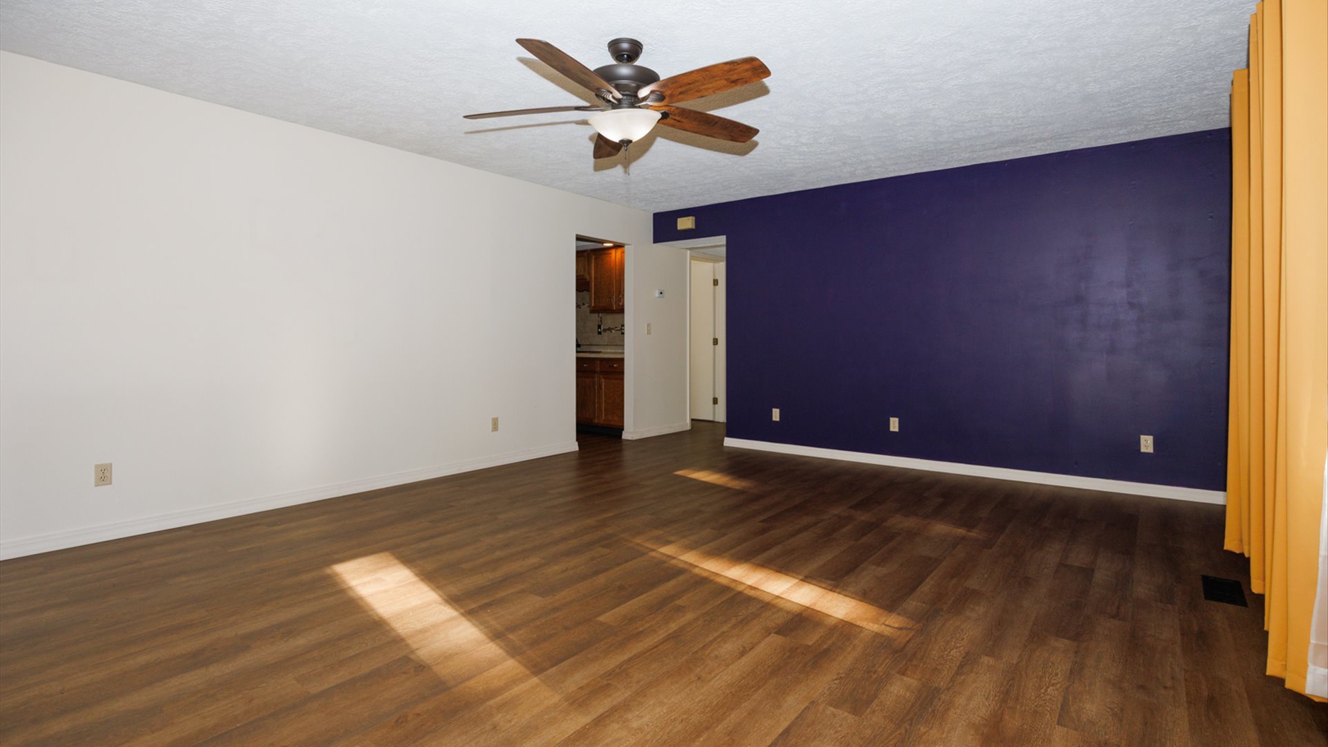 800 West Hamilton Street Atlanta, IL 61723 - Photo 6 of 44 a view of a room with wooden floor and a ceiling fan