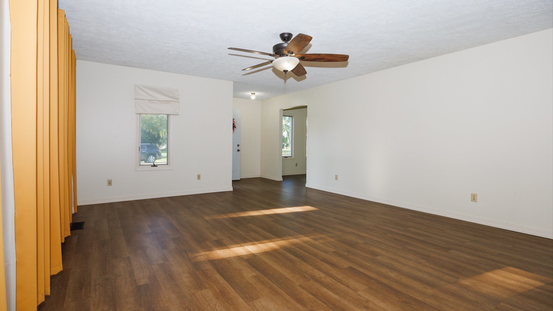 800 West Hamilton Street Atlanta, IL 61723 - Photo 7 of 44 a view of an empty room with wooden floor and a window
