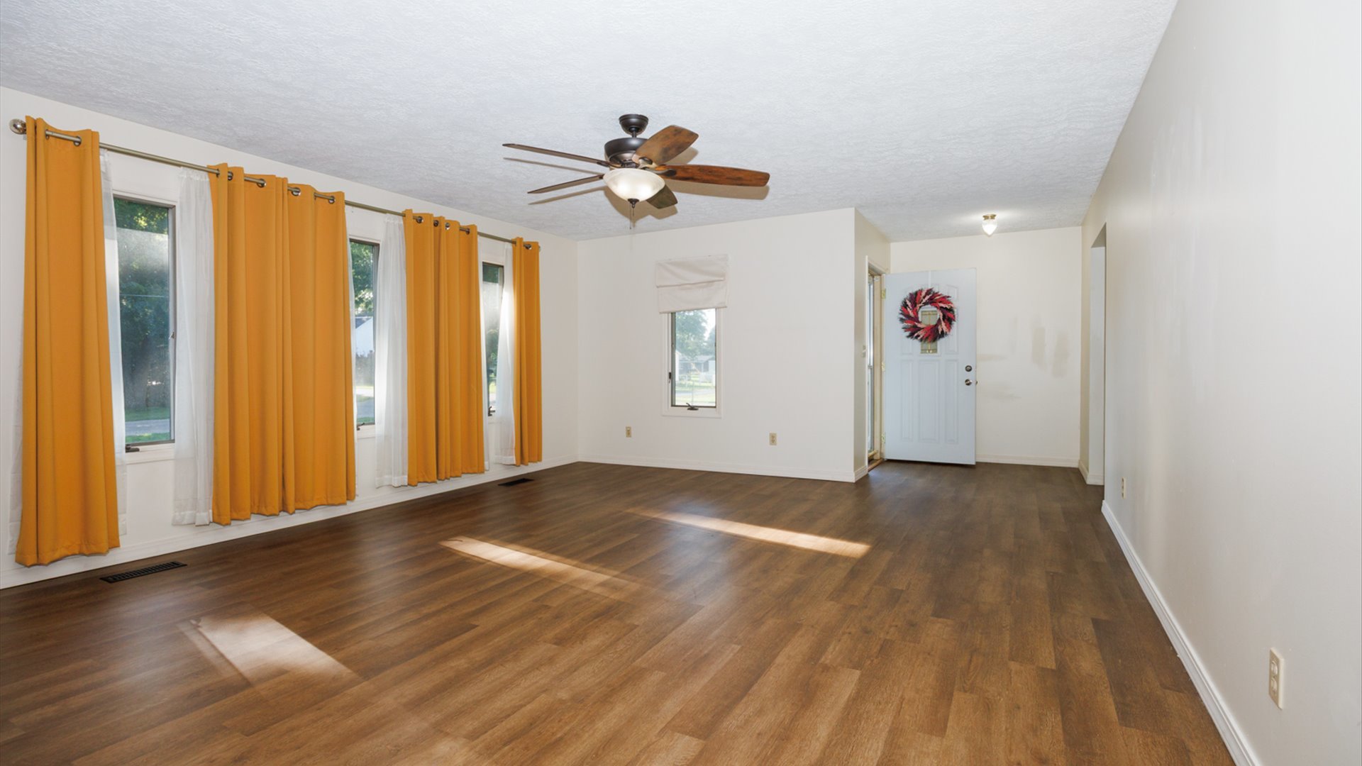 800 West Hamilton Street Atlanta, IL 61723 - Photo 8 of 44 a view of an empty room with window and wooden floor