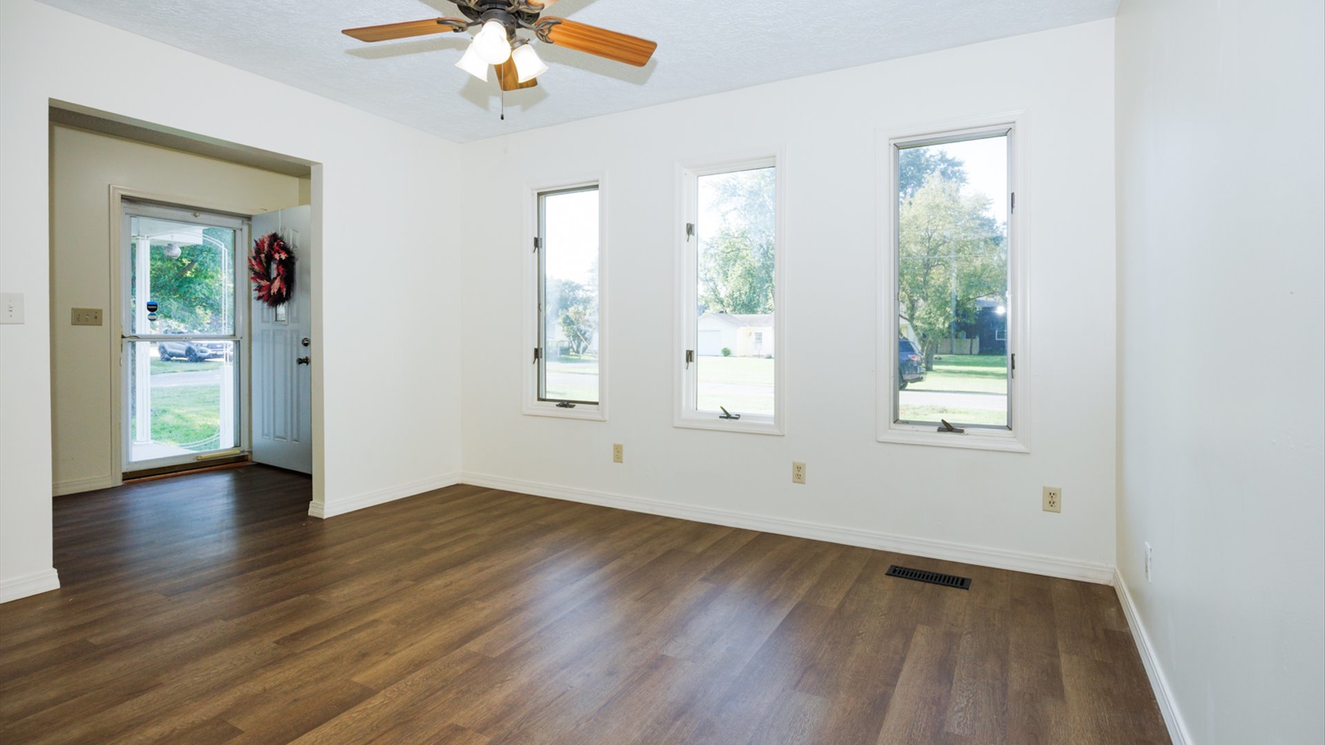 800 West Hamilton Street Atlanta, IL 61723 - Photo 10 of 44 a view of an empty room with wooden floor and a window