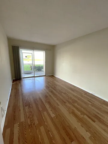 a view of an empty room and wooden floor