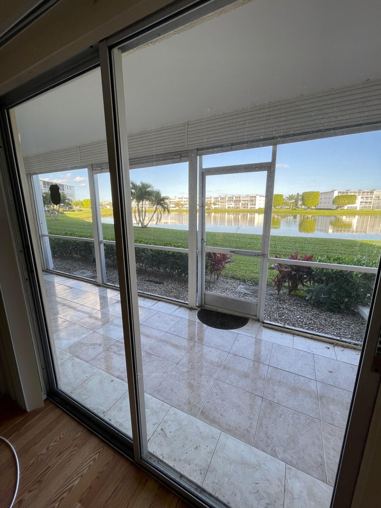1020 Exeter, Unit 1020 Boca Raton, FL 33434 - Photo 13 of 29 a view of a room with wooden floor and windows