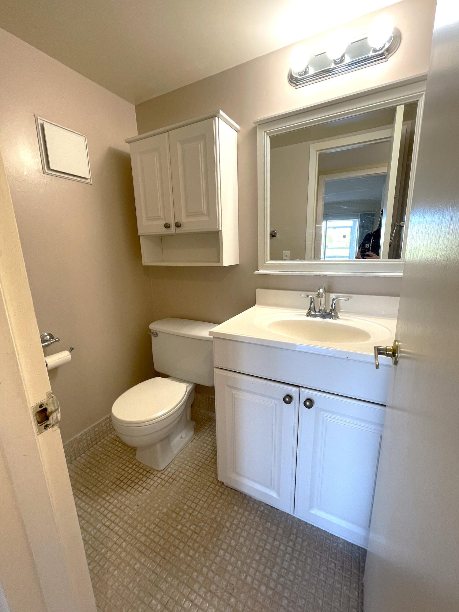 1020 Exeter, Unit 1020 Boca Raton, FL 33434 - Photo 17 of 29 a bathroom with a sink a toilet and mirror