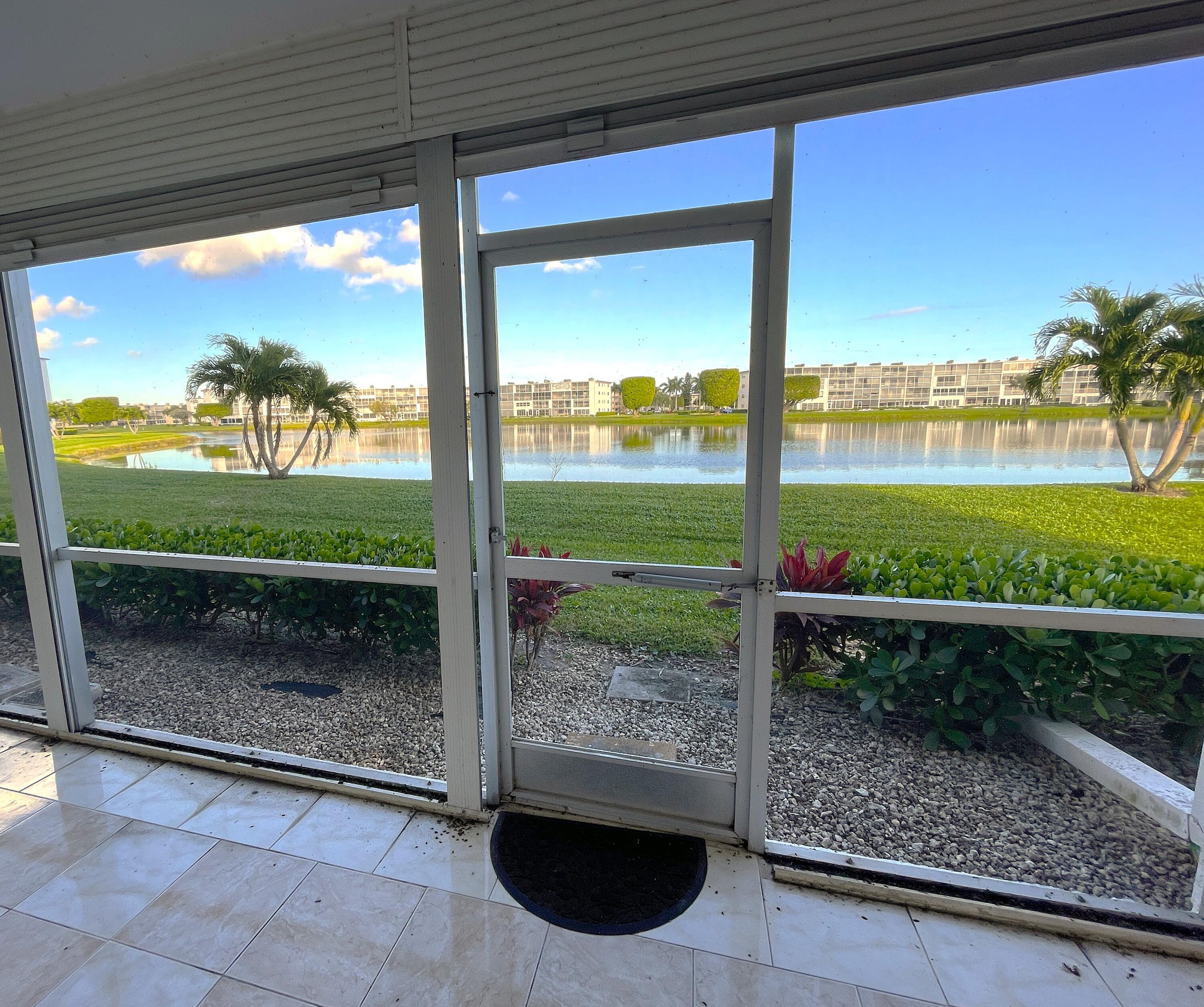 1020 Exeter, Unit 1020 Boca Raton, FL 33434 - Photo 19 of 29 a view of a porch and a yard