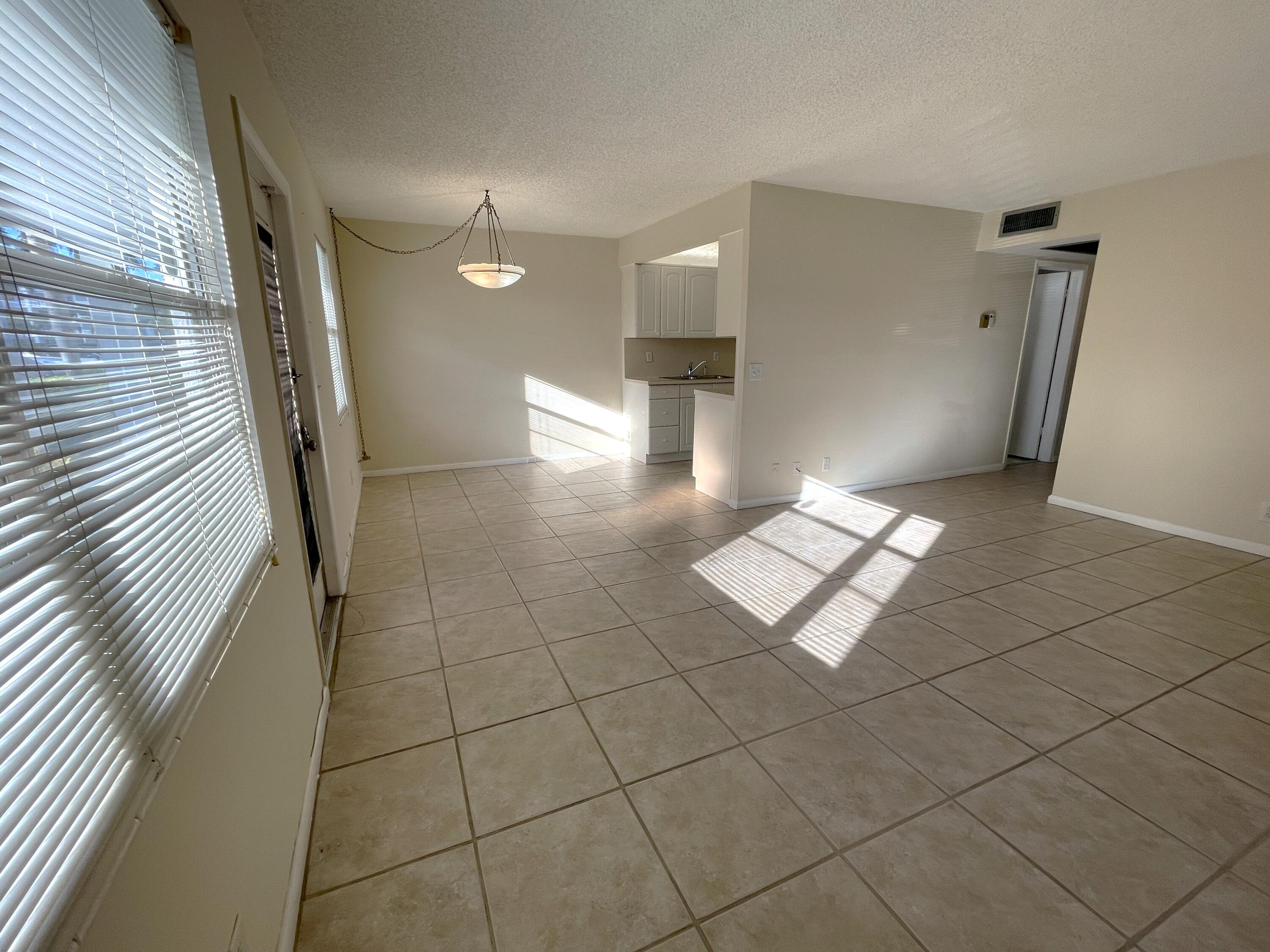 1020 Exeter, Unit 1020 Boca Raton, FL 33434 - Photo 4 of 29 a view of a hallway with windows