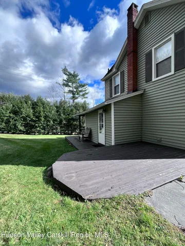 a view of house with backyard and garden