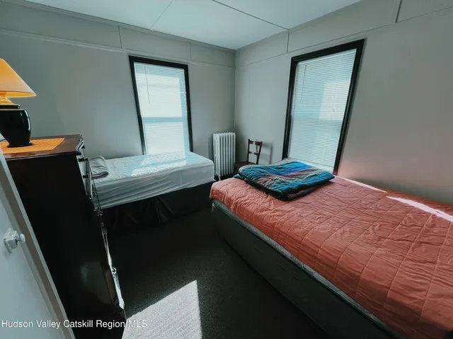 a bedroom with a bed and a mirror