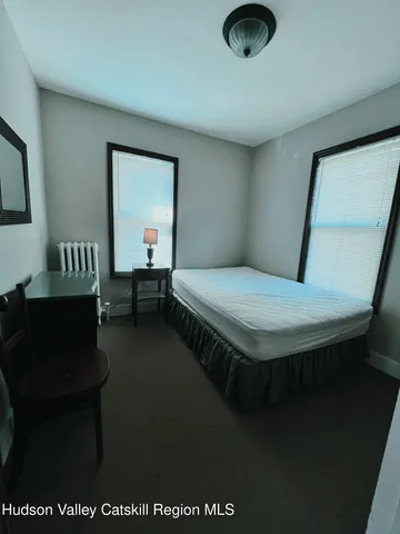 a bedroom with a bed and chair