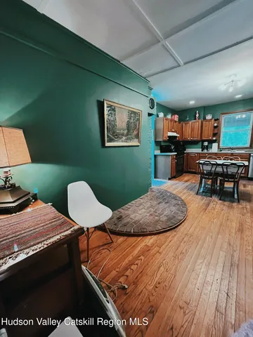 a bedroom with furniture and a wooden floor