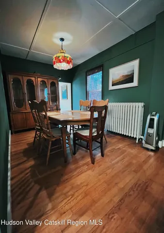 a dining room with a wooden table and chairs