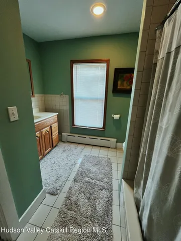 a bathroom with a sink a toilet and a shower