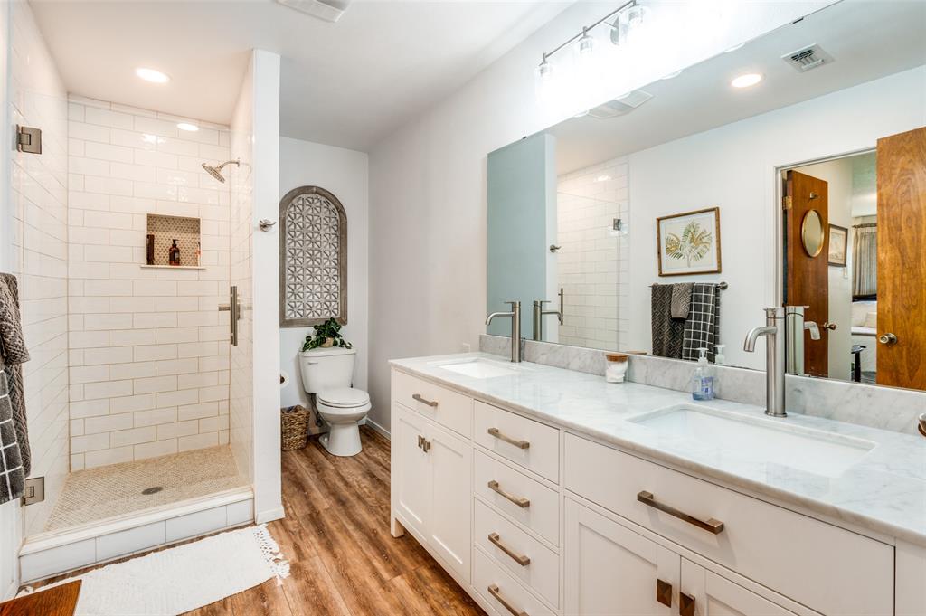 182 Huts Crossing Sadler, TX 76264 - Photo 18 of 40 a spacious bathroom with a granite countertop sink mirror and shower