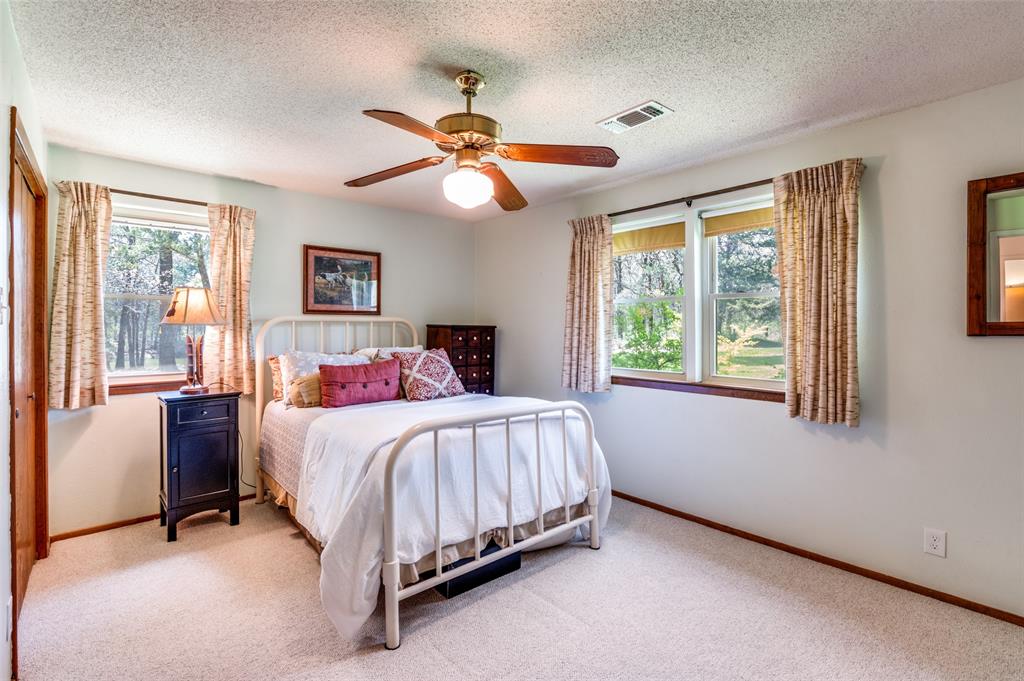 182 Huts Crossing Sadler, TX 76264 - Photo 19 of 40 a bed room with a bed and a chandelier
