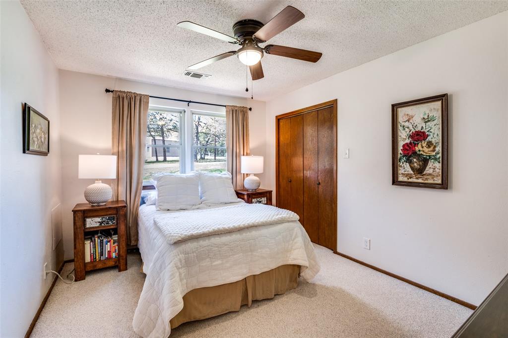 182 Huts Crossing Sadler, TX 76264 - Photo 20 of 40 a bedroom with a bed and a chandelier