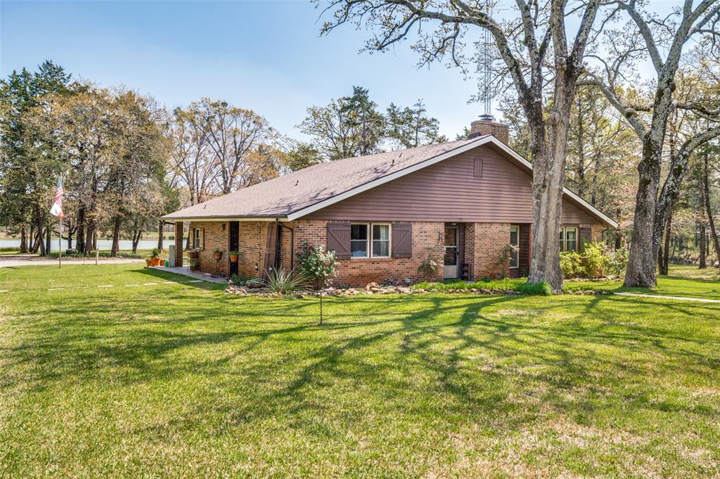 182 Huts Crossing Sadler, TX 76264 - Photo 4 of 40 a front view of a house with a garden