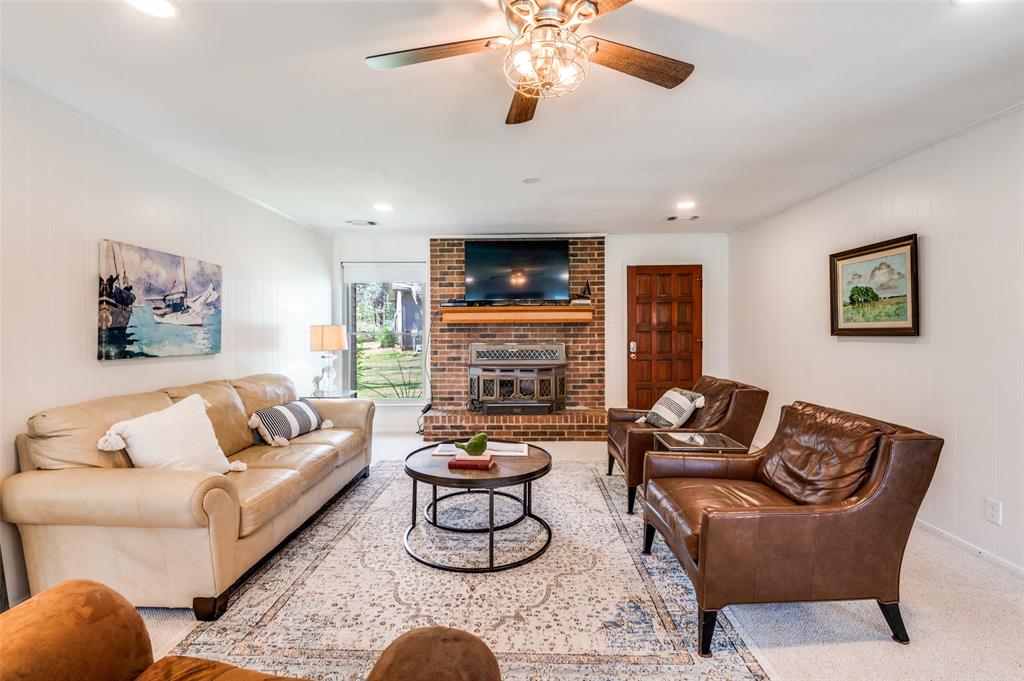 182 Huts Crossing Sadler, TX 76264 - Photo 5 of 40 a living room with furniture a flat screen tv and a fireplace